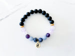 anti anxiety bracelet with rose quartz, amethyst, angelite, sodalite, lava stones, gold spacer beads, and a gold everlur charm