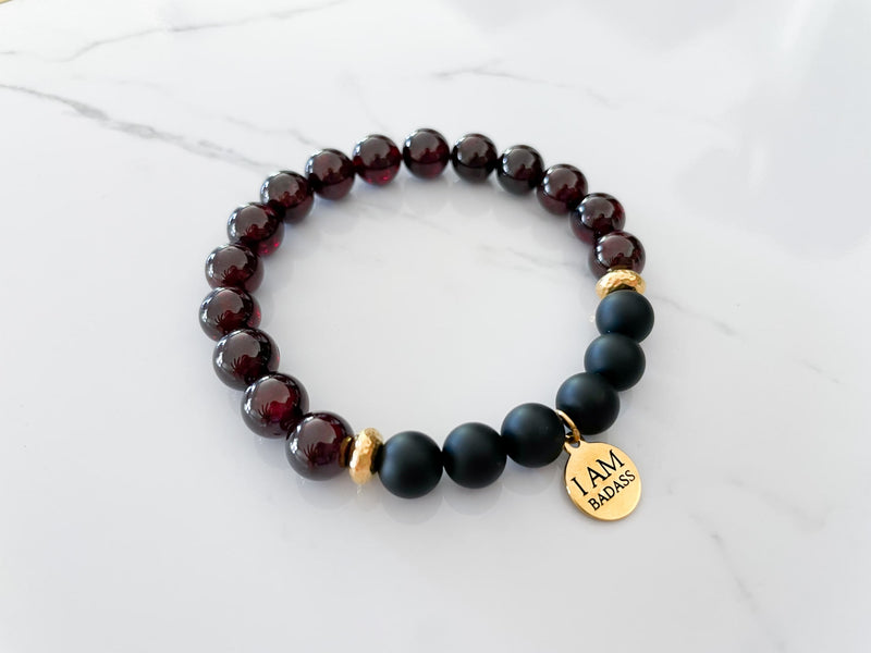 badass bracelet side view with 8mm garnet and onyx crystal beads, non tarnish gold plated spacer beads, and 18k gold plated stainless steal I AM Badass everlur charm