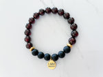 badass bracelet top view with 8mm garnet and onyx crystal beads, non tarnish gold plated spacer beads, and 18k gold plated stainless steal I AM Badass everlur charm