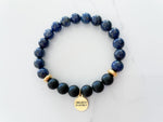 believe bracelet top view with 8mm lapis lazuli beads and onyx beads, non tarnish gold plated spacer beads, and 18k gold plated stainless steal I Believe in myself everlur charm