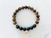 brave bracelet top view with 8mm tiger's eye beads and onyx beads, non tarnish gold plated spacer beads, and 18k gold plated stainless steal I am brave everlur charm