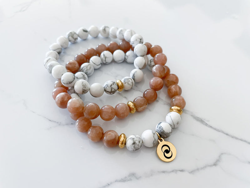 three piece confidence bracelet with one peach moonstone bracelet and one howlite bracelet